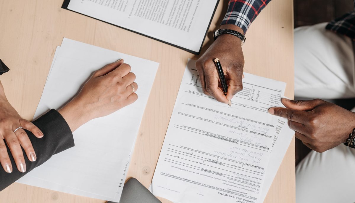 Freelancer reviewing paperwork at a desk
