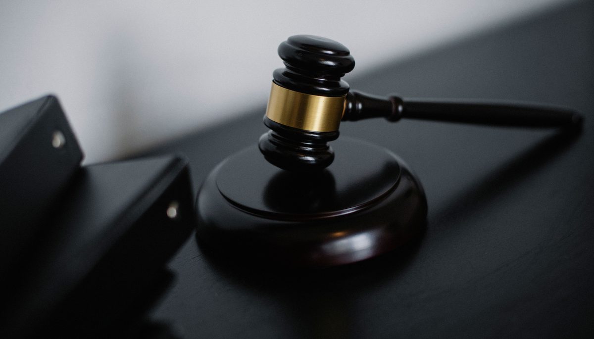 Wooden gavel resting on a dark desk